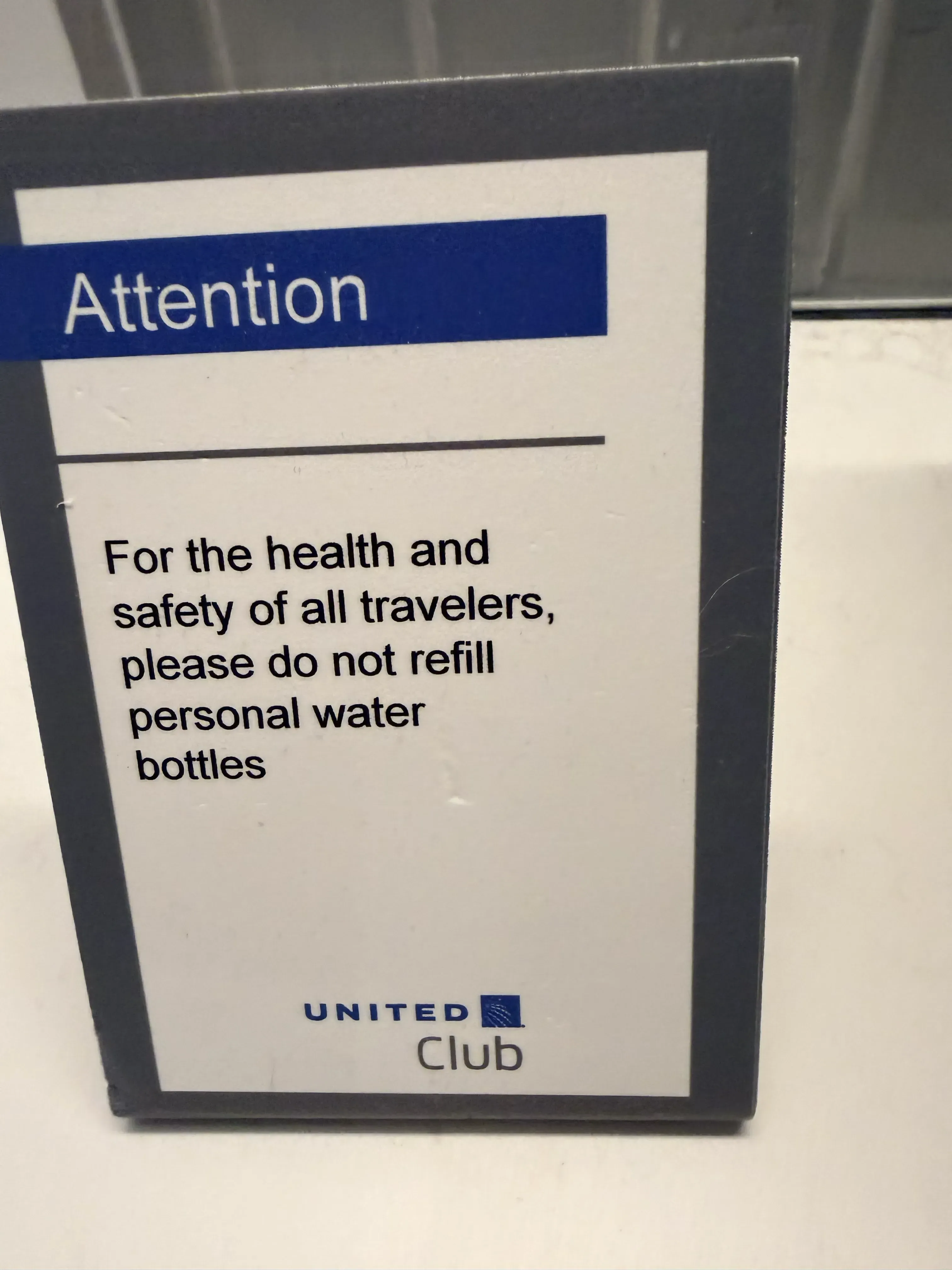 United Club water bottle prohibition sign