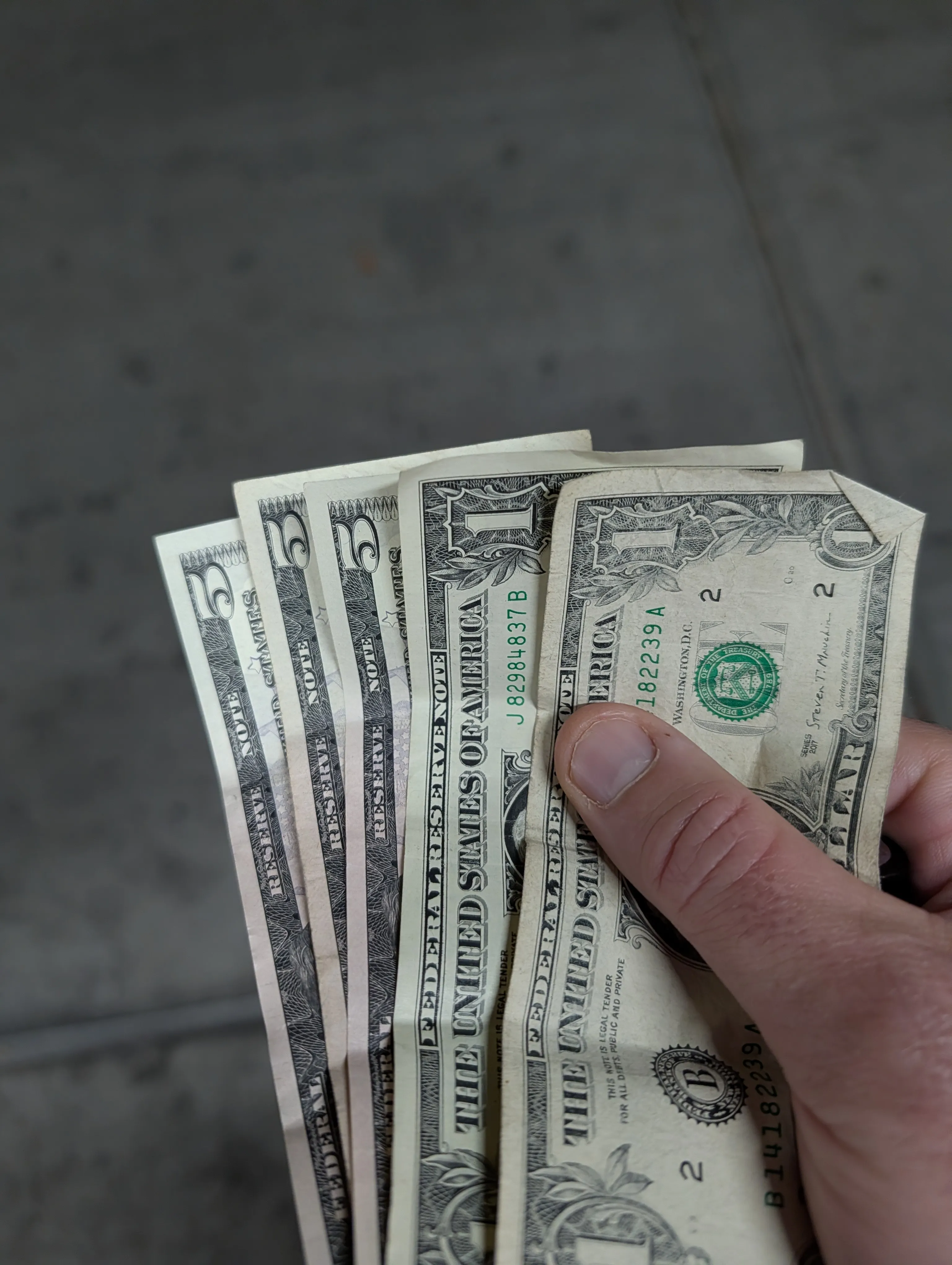 $17 in cash — three fives and two ones